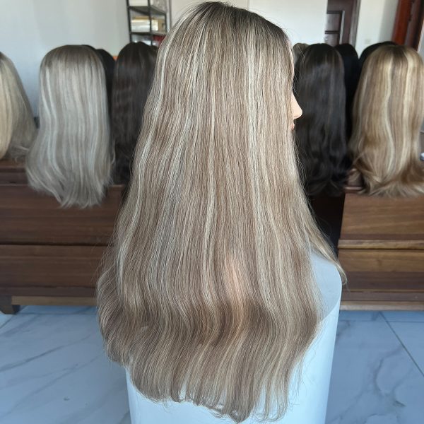 A 24-inch lace top wig made from 100% Virgin Human Hair, showcasing dark roots that transition into ash blonde with platinum blonde highlights. Sleek, flowing texture with a natural scalp effect.