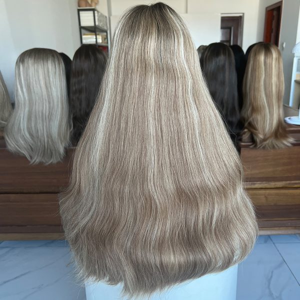 A 24-inch lace top wig made from 100% Virgin Human Hair, showcasing dark roots that transition into ash blonde with platinum blonde highlights. Sleek, flowing texture with a natural scalp effect.