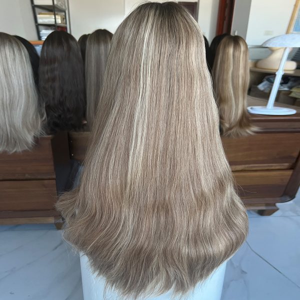 A 24-inch lace top wig made from 100% Virgin Human Hair, showcasing dark roots that transition into ash blonde with platinum blonde highlights. Sleek, flowing texture with a natural scalp effect.