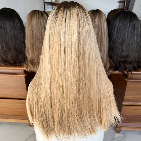 Experience luxury with the Golden Luxe Silk Top Lace Wig, crafted from 100% Virgin Human Hair. This 20-inch wig features a silk top and lace base for a natural scalp effect, sleek straight texture, and radiant blonde tone, perfect for elegant and versatile styling.